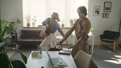 Multiethnic Colleagues Dancing Playfully at End of Workday Stock Footage 345230234