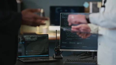Multiethnic Colleagues Discussing Code in Cybersecurity Office 스톡 동영상 346817920