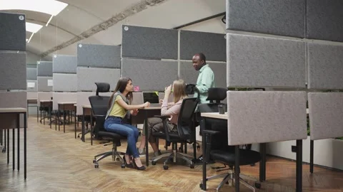 Multiethnic colleagues discussing project and using laptop Stock Footage 142539966