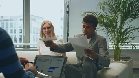 Multiethnic colleagues with papers in office Stock Footage 151960859