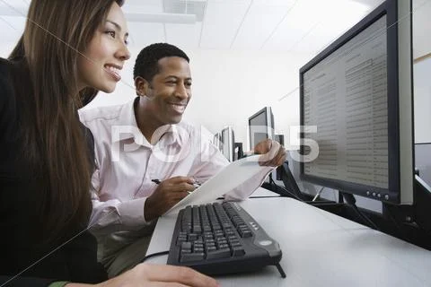 Multiethnic Colleagues Working On Computer Together Stock Photos