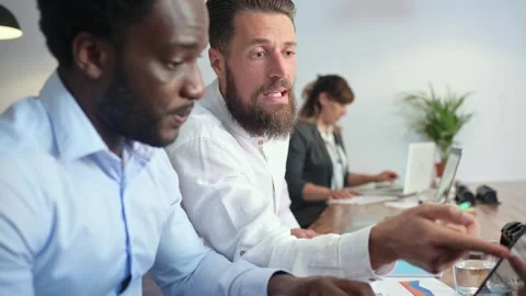 Multiethnic colleagues working on laptop Stock Footage 269345001
