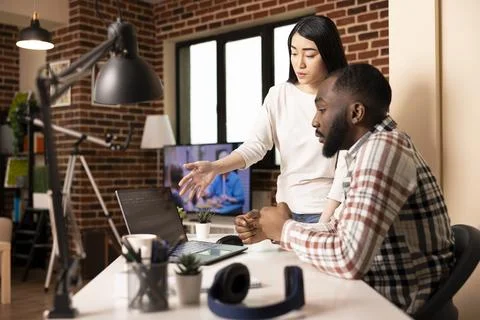 Multiethnic couple brainstorming on app development Stock Photos