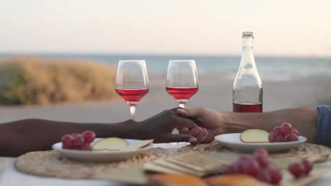 Multiethnic couple holding hands during romantic date by the sea Stock Footage 270248487