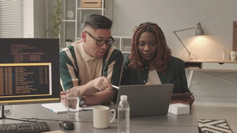 Multiethnic Couple of Programmers Developing Software in Office Video stock 195977666