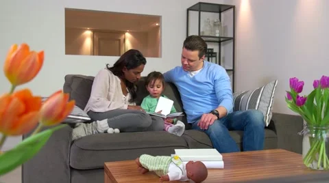 Multiethnic Couple Reading Book To Child Man Woman Daughter Baby Stock Footage 62142191