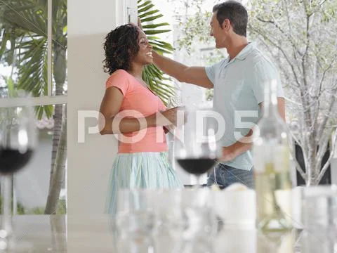 Multiethnic Couple Talking On Patio Stock Photos