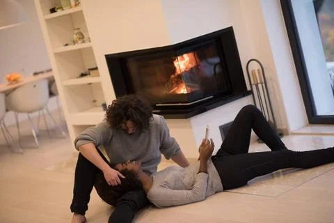 Multiethnic couple using tablet computer on the floor beautiful young mult... Stock Photos