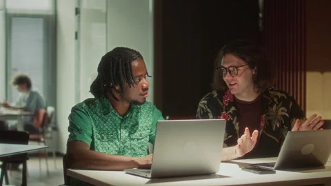 Multiethnic Coworkers Discussing Digital Project on Laptop in Office Stock Footage 340496597