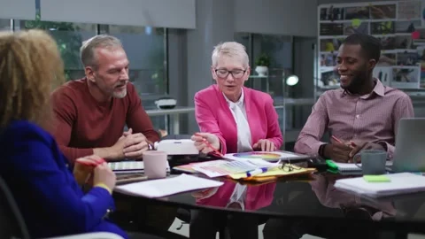 Multiethnic creative colleagues sit at desk and discuss project in loft office Stock Footage 189233091