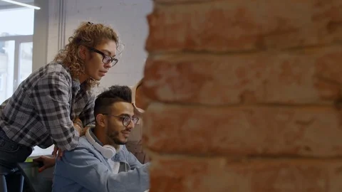 Multiethnic Creative Team Discussing Project on Laptop Stock Footage 126137178