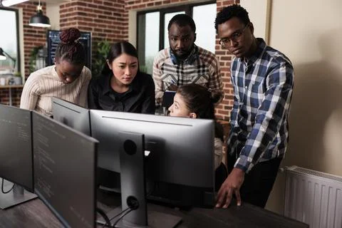 Multiethnic cyber security team developing software algorithm for information Stock Photos