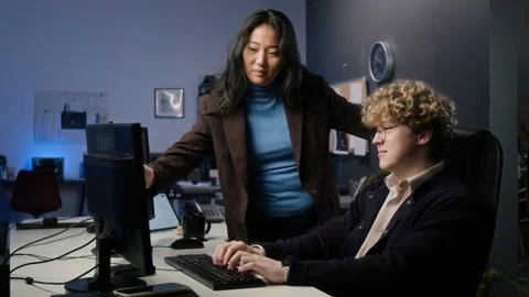 Multiethnic Cybersecurity Analysts Coding on Computer in Office Stock Footage 347288639