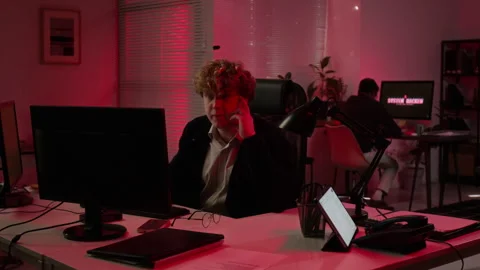 Multiethnic Cybersecurity Analysts Handling System Breach in Office Stock Footage 347309576