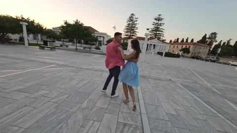 Multiethnic dance partners dancing to music in city, 360 drone shot Stock Footage 281339991