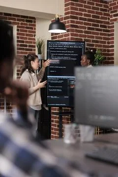 Multiethnic developer team talking about rising number of system security 写真素材