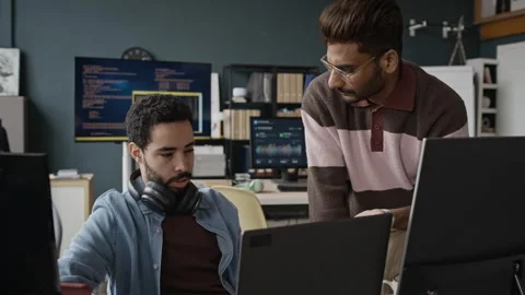 Multiethnic Developers Collaborating on Software Project in Modern Office Stock Footage 337483302