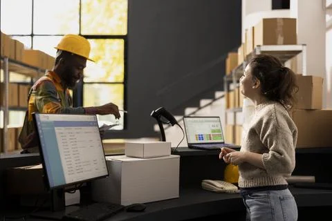 Multiethnic dispatch team focused on parcel preparation and stock management Stock Photos