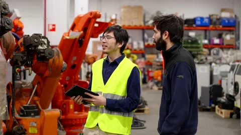 Multiethnic employees doing inventory in a factory Stock Footage 260577136