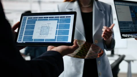 Multiethnic engineering team examines silicon wafer, trialing advanced materials Stock Footage 335882687