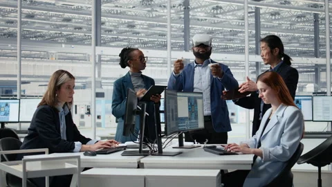 Multiethnic engineering team in semiconductors factory office using VR headset Stock Footage 335880340