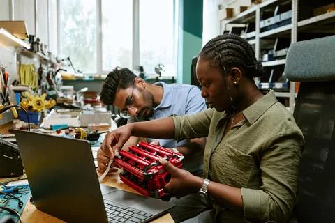 Multiethnic Engineers Assembling Robotic Prototype in Lab 写真素材