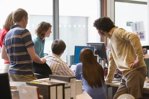 Multiethnic Executives Around Colleague Using Computer 스톡 사진