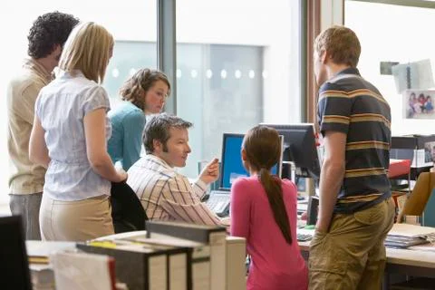 Multiethnic Executives Around Colleague Using Computer Stock Photos