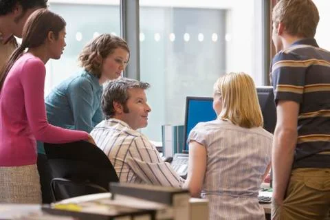 Multiethnic Executives Around Colleague Using Computer 스톡 사진
