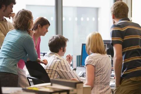 Multiethnic Executives Around Colleague Using Computer Stock Photos