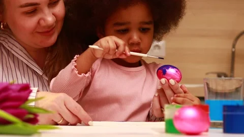 Multiethnic family preparing to easter event at kitchen painting eggs Stock Footage 169935140