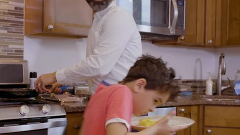 Multiethnic father and son making eggs 6 Stock Footage 89351081