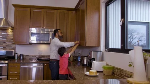 Multiethnic father and son setting the table 3 Stock Footage 89352081