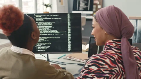 Multiethnic Female Programmers Chatting while Program Coding Stock Footage 241266743
