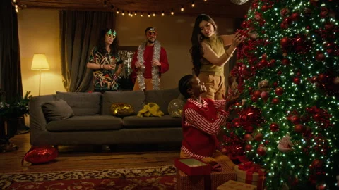 Multiethnic Friends Decorating Christmas Tree at Holiday Party Stock Footage 344395665