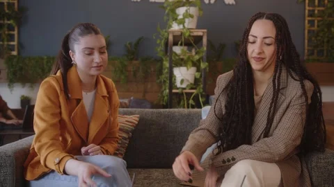 Multiethnic friends drinking coffee and chatting at city cafe Video stock 244601933