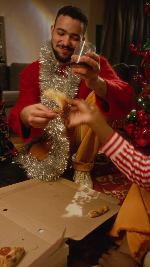Multiethnic Friends Eating Pizza during Christmas Celebration at Home Stock Footage 344409972