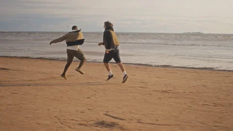 Multiethnic Friends Having Fun Playing Football on Sandy Beach Stock Footage 343257441