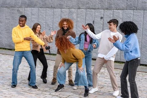 Multiethnic friends having fun while dancing outdoors. Foto stock
