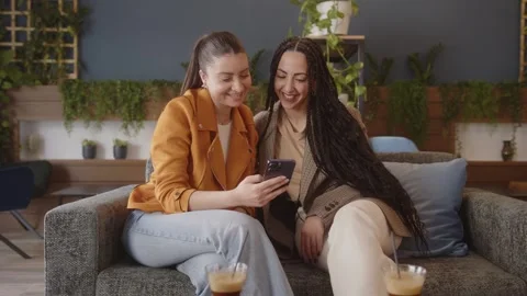 Multiethnic friends at home using smartphone and checking social media Video stock 244601748