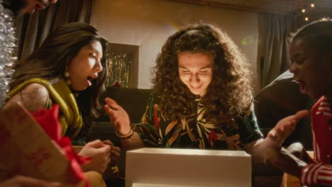 Multiethnic Friends Opening Glowing Gift Box at Holiday Party Stock Footage 345645144