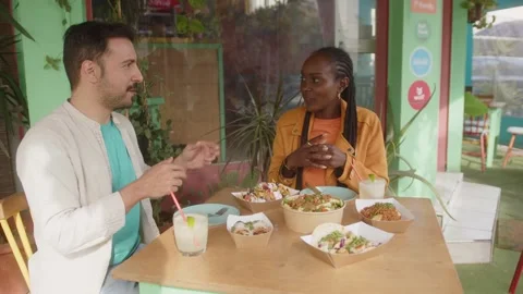 Multiethnic friends talking during lunch outdoors in summer Stock Footage 244545822