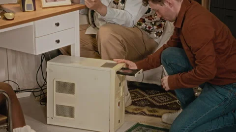 Multiethnic Friends Troubleshooting Retro Computer in Nostalgic Room Stock Footage 340276734