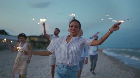 Multiethnic friends walking, dancing, having fun on night party at seaside with Stock Footage 198413651