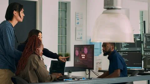 Multiethnic group of developers encountering system crash and hacking alert 写真素材