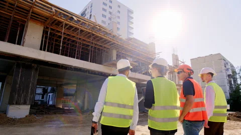 Multiethnic group of diverse specialists at construction site walking to the Stock Footage 152079965