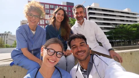 Multiethnic group of doctors and nurses taking selfie outdoors Stock Footage 338250592