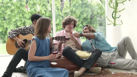 Multiethnic group of friends having fun playing guitar and singing together Stock Footage 254001177