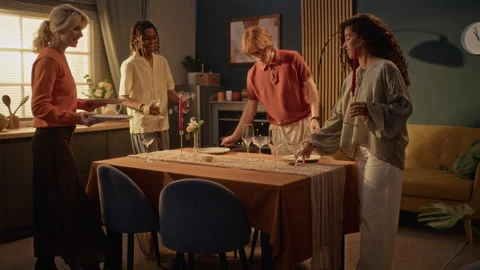 Multiethnic Group of Friends Setting Table for Dinner Party at Home Stock Footage 345228956