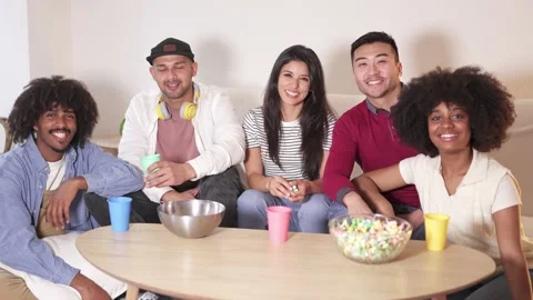 Multiethnic group of friends smiling at camera at home Stock Footage 237628490